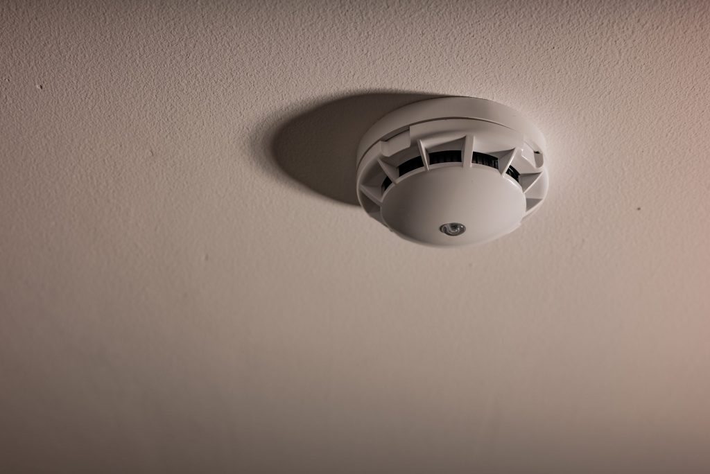 Alarm fire detected Smoke detector on white ceiling