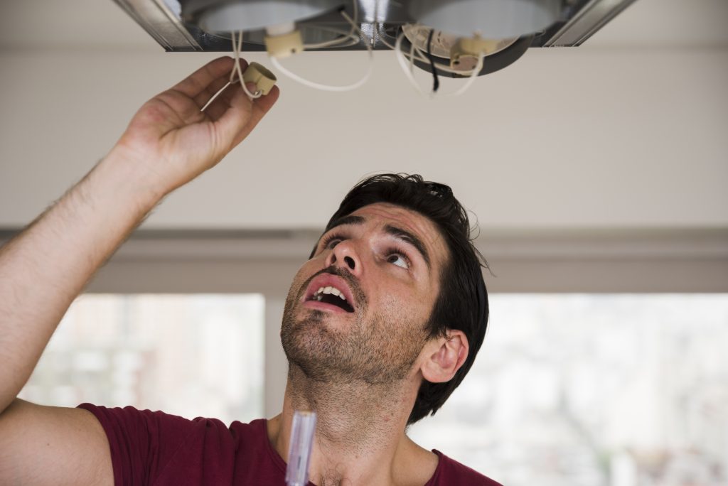 close-up-male-electrician-installing-holder-ceiling-light